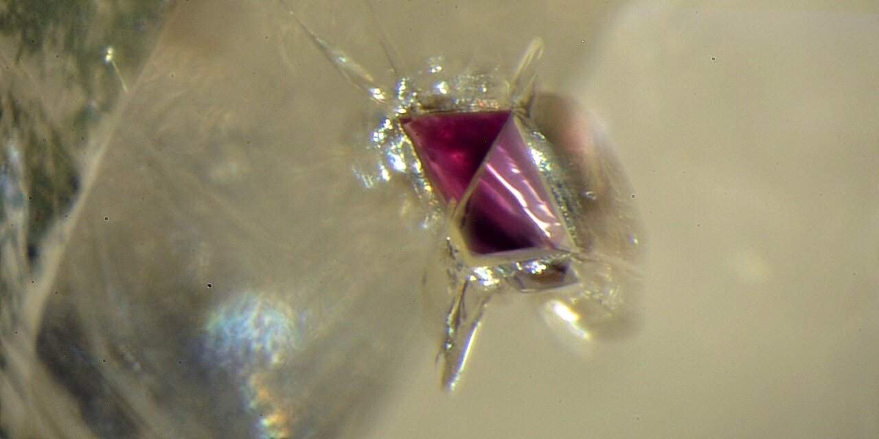 Diamond with 2025 ruby inclusion